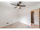 Bright bedroom features a ceiling fan, neutral carpet, and a closet at 3109 Albatross Ln, Decatur, GA 30034