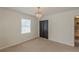 Bedroom with decorative light fixture, neutral carpet and view into another room at 3109 Albatross Ln, Decatur, GA 30034