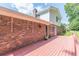 Spacious red wood deck extends from the home with a brick exterior and lush yard at 3109 Albatross Ln, Decatur, GA 30034