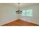 Dining room featuring hardwood floors, chandelier, and natural light from a window at 3109 Albatross Ln, Decatur, GA 30034