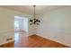 Dining room with hardwood floors and chandelier; open to living room at 3109 Albatross Ln, Decatur, GA 30034