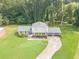 Well-maintained home with a two-car garage, manicured lawn, and a curved driveway at 3109 Albatross Ln, Decatur, GA 30034