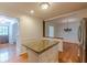 Updated kitchen with granite island bar top connecting to dining and entrance foyer at 3109 Albatross Ln, Decatur, GA 30034