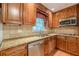 Close up of a kitchen with stainless steel appliances, granite countertops, and custom cabinets at 3109 Albatross Ln, Decatur, GA 30034