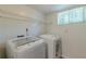 Bright laundry room includes modern washer and dryer and shelving at 3109 Albatross Ln, Decatur, GA 30034