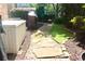 Landscaped backyard with stone pavers, green grass, and a garden storage box at 7825 Crownpoint Dr, Alpharetta, GA 30005