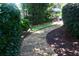 Stone pathway in a lush backyard, creating a serene and inviting outdoor space at 7825 Crownpoint Dr, Alpharetta, GA 30005