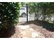 Gated backyard entrance with mature greenery and a stone pathway at 7825 Crownpoint Dr, Alpharetta, GA 30005