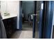 Well-lit bathroom with a modern vanity, granite countertop, and view into adjacent bedroom at 7825 Crownpoint Dr, Alpharetta, GA 30005