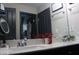 Bathroom featuring a double sink vanity, quartz countertop, and stylish fixtures at 7825 Crownpoint Dr, Alpharetta, GA 30005