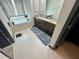 Bathroom with double sinks, soaking tub, and tile flooring at 7825 Crownpoint Dr, Alpharetta, GA 30005