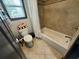 Well-lit bathroom featuring a bathtub, toilet, and window with natural light at 7825 Crownpoint Dr, Alpharetta, GA 30005