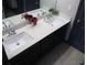 Stylish bathroom with double vanity, quartz countertops, and dark wood cabinets at 7825 Crownpoint Dr, Alpharetta, GA 30005