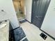 Bright bathroom featuring a glass-enclosed shower, gray tile floor, and modern fixtures at 7825 Crownpoint Dr, Alpharetta, GA 30005