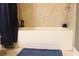 A bathtub with tile surround and chrome fixtures enhances this bathroom at 7825 Crownpoint Dr, Alpharetta, GA 30005