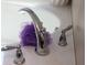 Close up of chrome bathtub faucet and jets with a white tub at 7825 Crownpoint Dr, Alpharetta, GA 30005