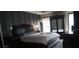 Bedroom with high ceilings, panel walls, neutral colors, and a wooden bed frame at 7825 Crownpoint Dr, Alpharetta, GA 30005