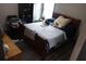 Comfortable bedroom with a classic bed, a dark wood cabinet, and soft natural light at 7825 Crownpoint Dr, Alpharetta, GA 30005