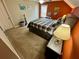 Bedroom with neutral colors, orange accent wall, carpet flooring, and a dresser at 7825 Crownpoint Dr, Alpharetta, GA 30005