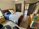 Bedroom with wood floors, furnishings, and ensuite bath at 7825 Crownpoint Dr, Alpharetta, GA 30005