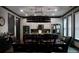 Dining room with an elaborate dark chandelier and dining table, with plentiful natural light from large windows at 7825 Crownpoint Dr, Alpharetta, GA 30005