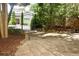 Gated entrance of a brick home with stone pathway and mature landscaping at 7825 Crownpoint Dr, Alpharetta, GA 30005
