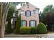 Charming two-story brick home with well-maintained landscaping and symmetrical design at 7825 Crownpoint Dr, Alpharetta, GA 30005