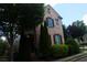 Charming two-story brick home with manicured landscaping and shuttered windows at 7825 Crownpoint Dr, Alpharetta, GA 30005