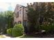 Charming two-story brick house surrounded by mature trees and manicured landscaping at 7825 Crownpoint Dr, Alpharetta, GA 30005