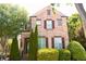 Charming two-story brick home with manicured landscaping and classic architectural details at 7825 Crownpoint Dr, Alpharetta, GA 30005