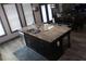 Kitchen island with a sink and a granite countertop, enhancing functionality and style at 7825 Crownpoint Dr, Alpharetta, GA 30005