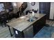 Kitchen island featuring granite countertops, stainless steel appliances, and a modern faucet at 7825 Crownpoint Dr, Alpharetta, GA 30005