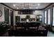 Modern kitchen with stainless steel appliances, island, and a dining table under pendant lighting at 7825 Crownpoint Dr, Alpharetta, GA 30005