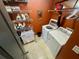 Functional laundry room with modern washer and dryer, storage shelves, and ample space at 7825 Crownpoint Dr, Alpharetta, GA 30005