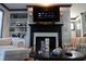 Cozy living room featuring a fireplace, built-in bookshelves, and comfortable seating at 7825 Crownpoint Dr, Alpharetta, GA 30005