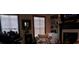 Cozy living room featuring a fireplace, a comfortable armchair, and built-in bookshelves at 7825 Crownpoint Dr, Alpharetta, GA 30005
