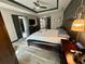 Well-appointed main bedroom with tray ceilings, neutral colors, stylish furniture and wood-look flooring at 7825 Crownpoint Dr, Alpharetta, GA 30005