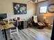 Comfortable home office featuring hardwood floors, a desk setup, and a relaxing armchair at 7825 Crownpoint Dr, Alpharetta, GA 30005
