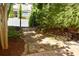 Stone path with a wrought iron gate leading to a well-manicured home and garden at 7825 Crownpoint Dr, Alpharetta, GA 30005