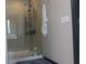 Modern shower with glass door, tiled walls, and contemporary fixtures at 7825 Crownpoint Dr, Alpharetta, GA 30005