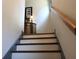 Carpeted staircase leading to the next level, complemented by neutral walls and wooden handrail at 7825 Crownpoint Dr, Alpharetta, GA 30005