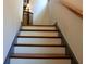 Classic staircase with white risers and stained treads, providing access to upper floors at 7825 Crownpoint Dr, Alpharetta, GA 30005