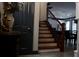 Staircase with wood treads and black railings offers an elegant transition between floors at 7825 Crownpoint Dr, Alpharetta, GA 30005