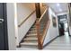 Carpeted staircase with wooden handrail and elegant iron spindles leading to the upper level at 7825 Crownpoint Dr, Alpharetta, GA 30005