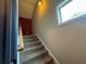 Staircase leading to a second floor featuring carpeted steps and window providing natural light at 7825 Crownpoint Dr, Alpharetta, GA 30005