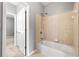 Tiled shower and bathtub combo in a bathroom with a view to a bedroom beyond at 1999 Barrett Knoll Nw Cir, Kennesaw, GA 30152