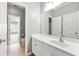 Bright bathroom with tile floor and a large mirror above the white vanity at 1999 Barrett Knoll Nw Cir, Kennesaw, GA 30152