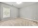 Neutral bedroom featuring a window for natural light and plush carpeting at 1999 Barrett Knoll Nw Cir, Kennesaw, GA 30152