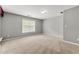Neutral bedroom featuring a window for natural light and plush carpeting at 1999 Barrett Knoll Nw Cir, Kennesaw, GA 30152