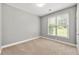 Neutral bedroom featuring a window for natural light and plush carpeting at 1999 Barrett Knoll Nw Cir, Kennesaw, GA 30152